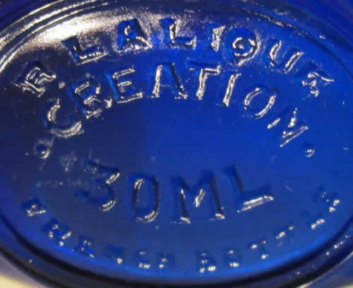 R. LALIQUE CREATION 30ML FRENCH BOTTLE molded signature on the underside of a round flask form blue glass Worth Dans La Nuit Perfume Bottle